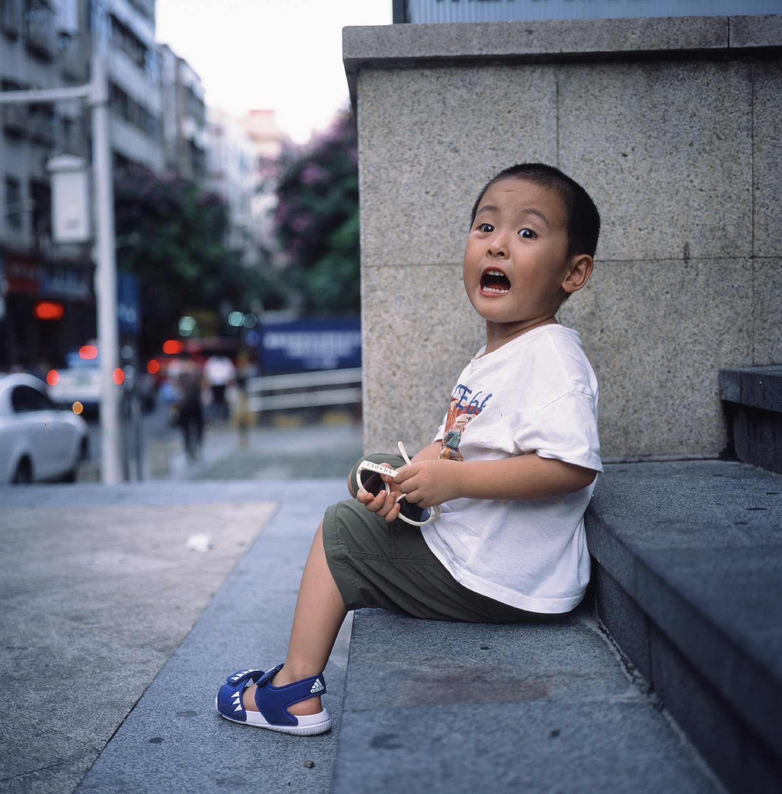 儿子坐在街边的台阶上,张大了嘴