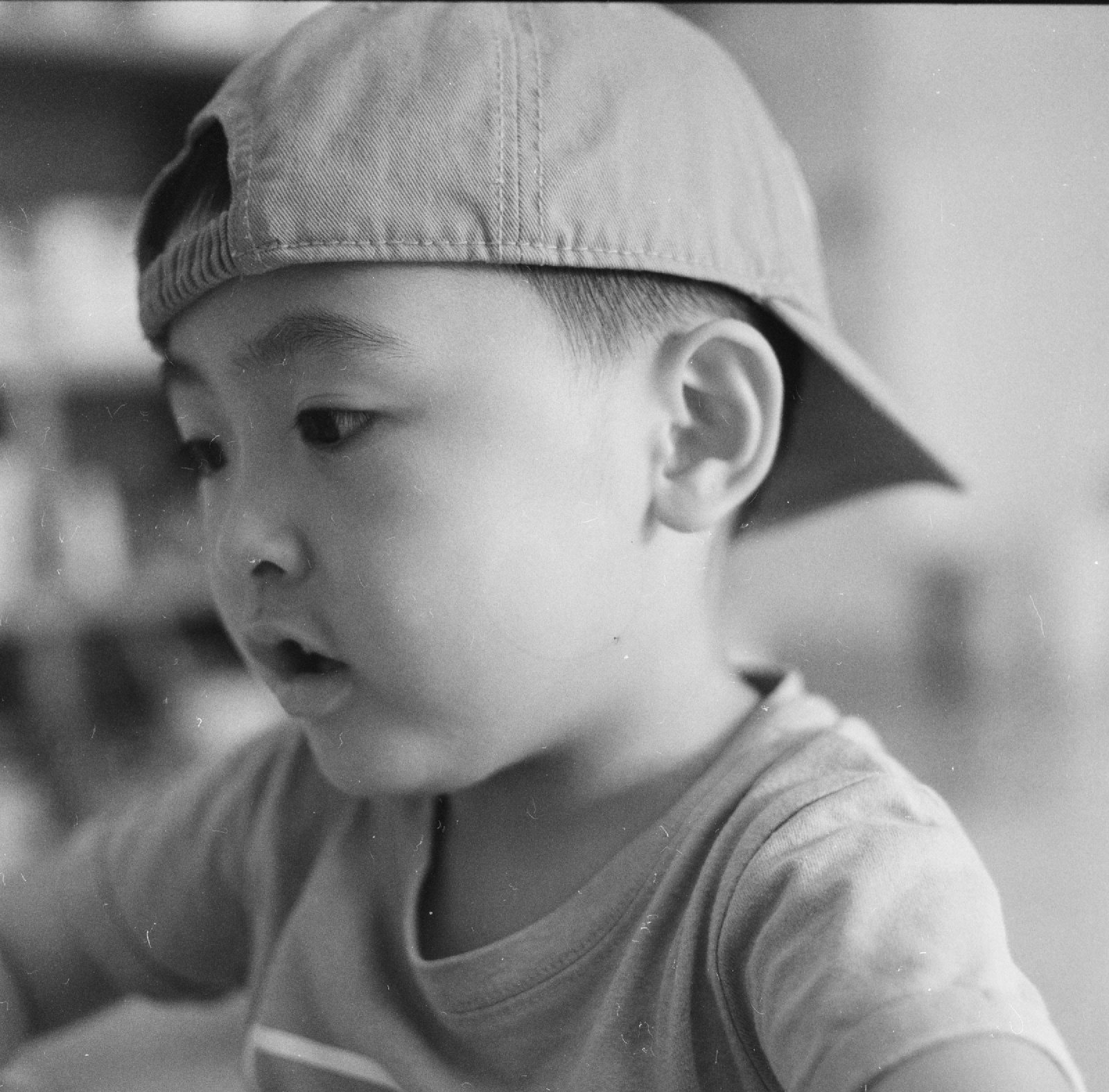 黑白，儿子反戴帽子，张着嘴看旁边